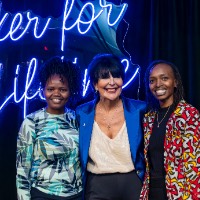 Two girls take a picture with President Mantella on stage.